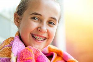 smiling child with braces 