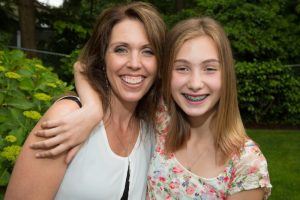 smiling mother and child with braces 