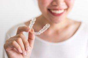 woman holding Invisalign in Powell 