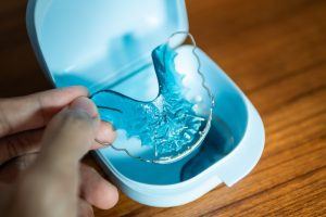 person holding blue retainer
