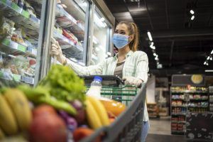 woman wearing mask while grocery shopping 