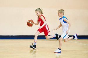 young girl playing basketball 