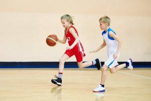 young girl playing basketball