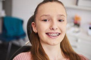 young girl with braces in dental office