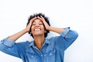 young woman enjoying headache relief thanks to orthodontist in Newark