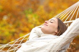 woman looking relaxed on hammock  