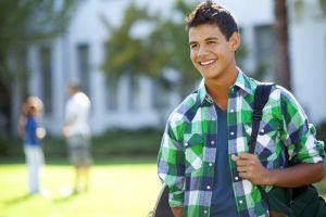 young boy at school with Invisalign TEEN