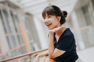 teen girl with braces leaning on railing