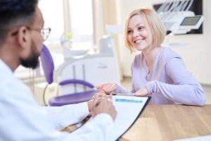 woman talking to orthodontist about dental insurance