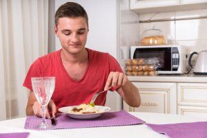 man eating alone at home 